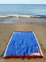 Beach towel in royal blue color with woven ribbons and tassels