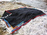 Beach towel in black color with woven ribbons and tassels