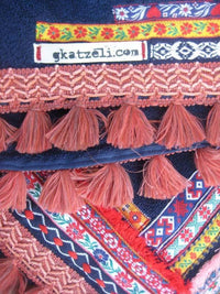 Beach towel in navy blue color with woven ribbons and tassels
