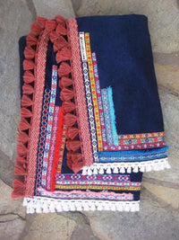 Beach towel in navy blue color with woven ribbons and tassels