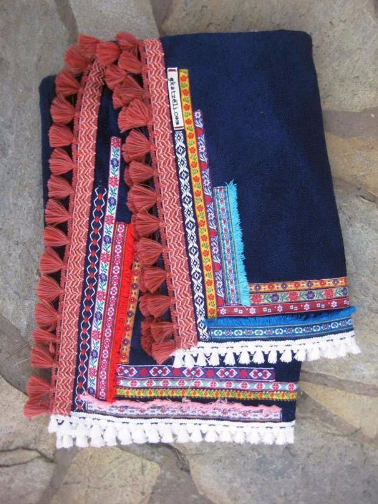 Beach towel in navy blue color with woven ribbons and tassels