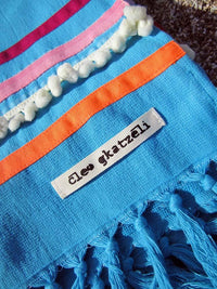 Peshtowel/towel in turquoise color with three different ribbons and a pom pom band