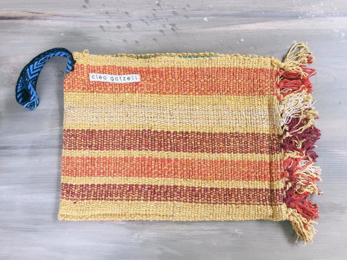 Rug clutch bag in yellow color and wide stripes