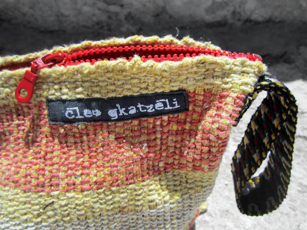 Rug clutch bag in yellow color and wide stripes