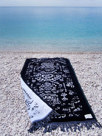 Reversible beach towel in black and white color with fringes