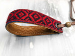 Leather bracelet with a red woven ribbon and Aztec pattern