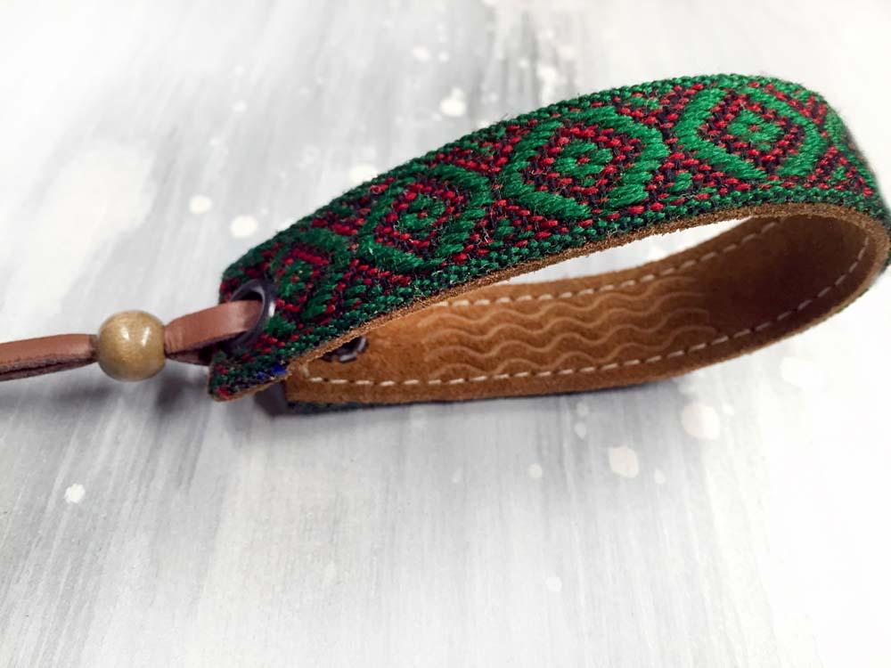 Leather bracelet with a green woven ribbon and Aztec pattern