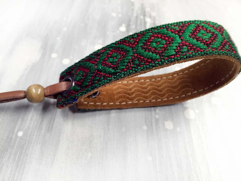 Leather bracelet with a green woven ribbon and Aztec pattern
