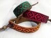 Leather bracelet with a woven ribbon and Aztec pattern