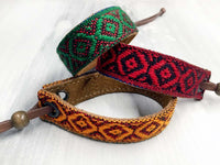 Leather bracelet with a woven ribbon and Aztec pattern