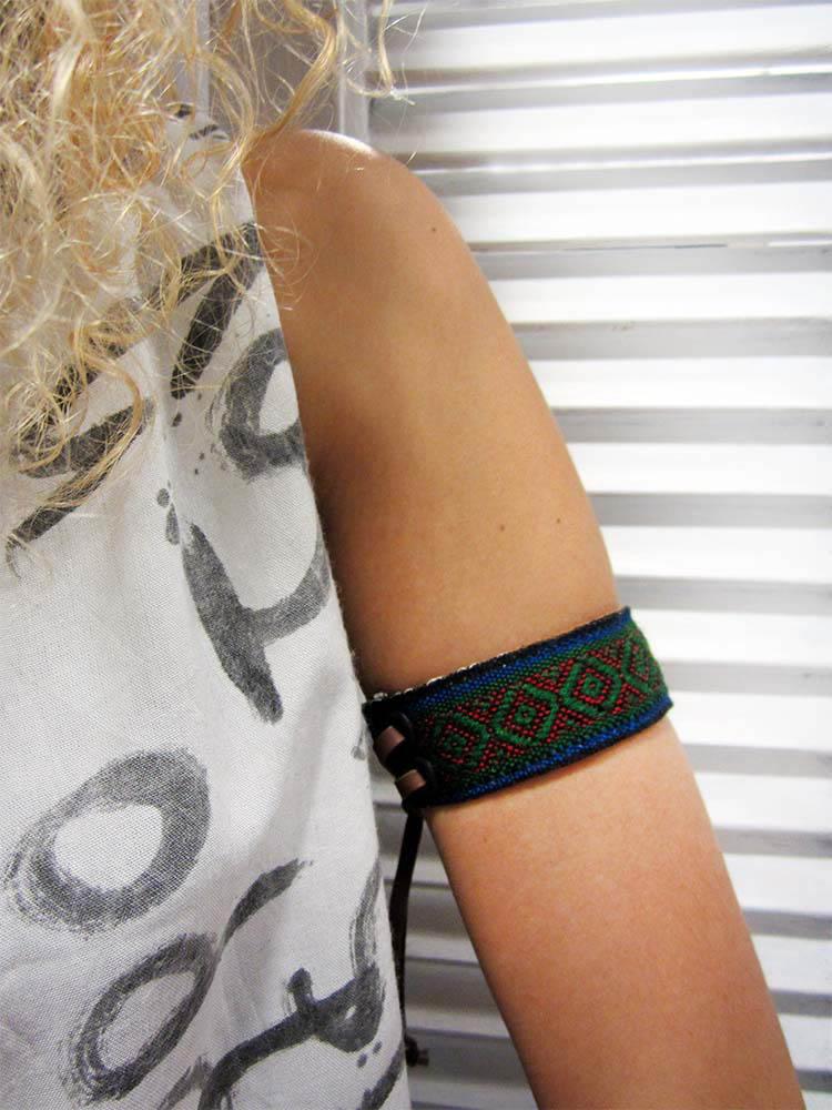 Leather bracelet with a green woven ribbon and Aztec pattern