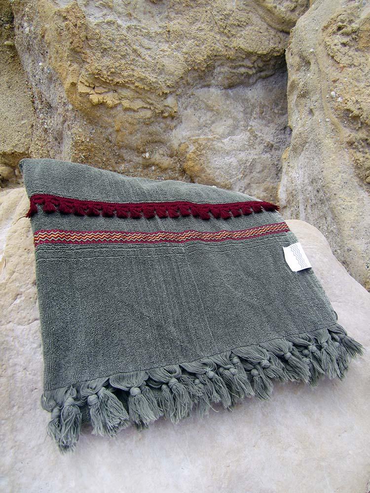 Peshtowel/towel in iron stonewashed color with a woven ribbon and a fringed band