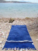 Peshtowel/towel in denim stonewashed color with a woven ribbon and a fringed band