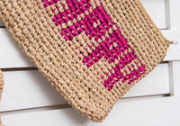 HAPPY woven straw clutch